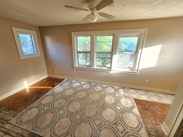 1110 Watkins St SE, Grand Rapids, MI 49507 - unfurnished room with plenty of natural light, a ceiling fan, a textured ceiling, and wood finished floors