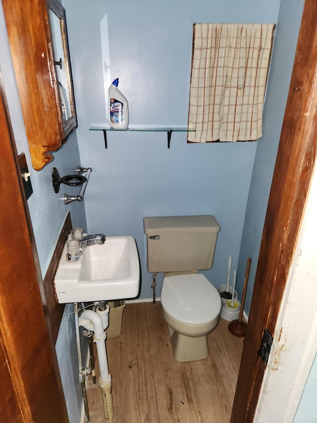 1110 Watkins St SE, Grand Rapids, MI 49507 - half bathroom featuring a sink and wood finished floors