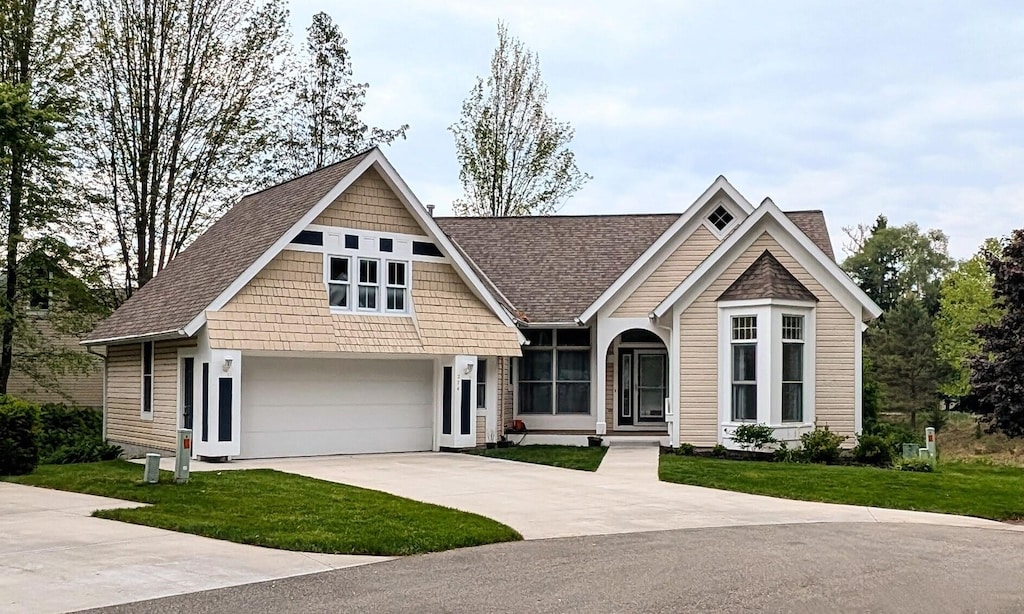 274 Willow Creek Ct, Holland, MI 49424 - view of front of house featuring a front lawn, driveway, and a shingled roof