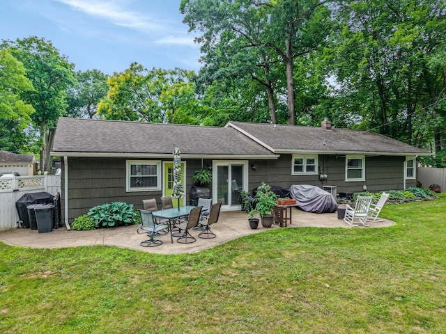 5674 Brunswick Blvd, Waterford, MI 48327 - back of property featuring a patio area, roof with shingles, and a chimney