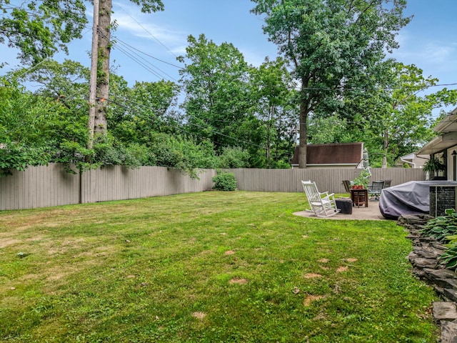 5674 Brunswick Blvd, Waterford, MI 48327 - fenced backyard with a patio area and a fire pit
