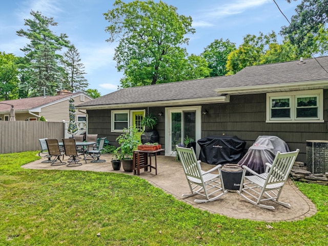 5674 Brunswick Blvd, Waterford, MI 48327 - rear view of house featuring a fire pit, a patio, and roof with shingles