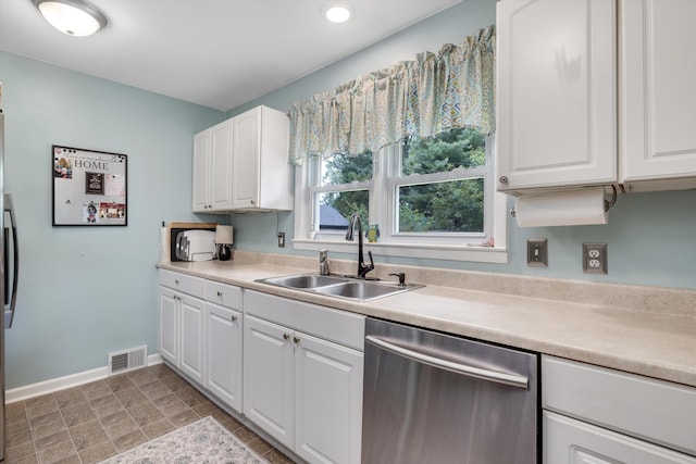 5674 Brunswick Blvd, Waterford, MI 48327 - kitchen with stainless steel dishwasher, white cabinets, light countertops, and recessed lighting