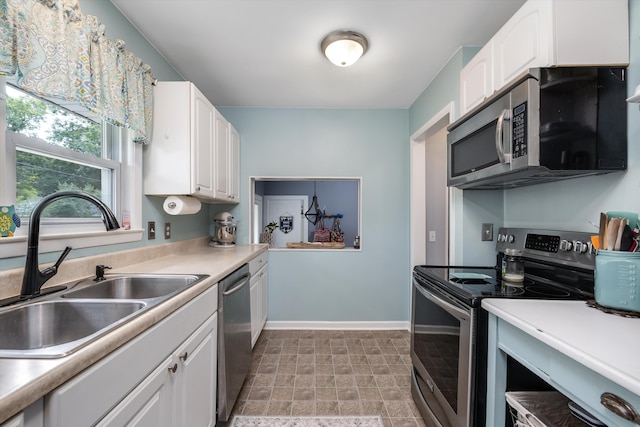 5674 Brunswick Blvd, Waterford, MI 48327 - kitchen featuring stainless steel appliances, white cabinetry, and light countertops