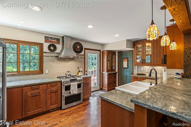 25740 Farmbrook Rd, Southfield, MI 48034 - kitchen with double oven range, island exhaust hood, brown cabinetry, tasteful backsplash, and recessed lighting