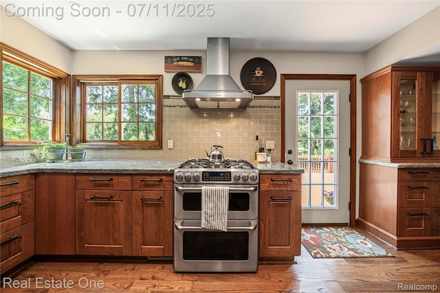 25740 Farmbrook Rd, Southfield, MI 48034 - kitchen with island range hood, double oven range, and brown cabinetry
