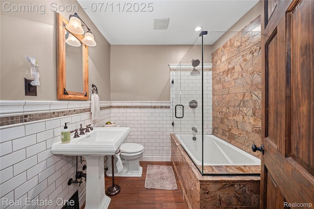 25740 Farmbrook Rd, Southfield, MI 48034 - full bathroom featuring tiled shower / bath, wood finished floors, a wainscoted wall, and tile walls
