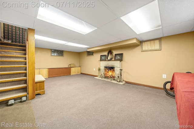25740 Farmbrook Rd, Southfield, MI 48034 - finished basement with carpet flooring, a paneled ceiling, a warm lit fireplace, and stairs