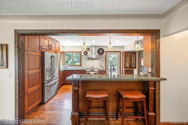25740 Farmbrook Rd, Southfield, MI 48034 - kitchen with high quality appliances, light wood-type flooring, a kitchen breakfast bar, extractor fan, and a peninsula