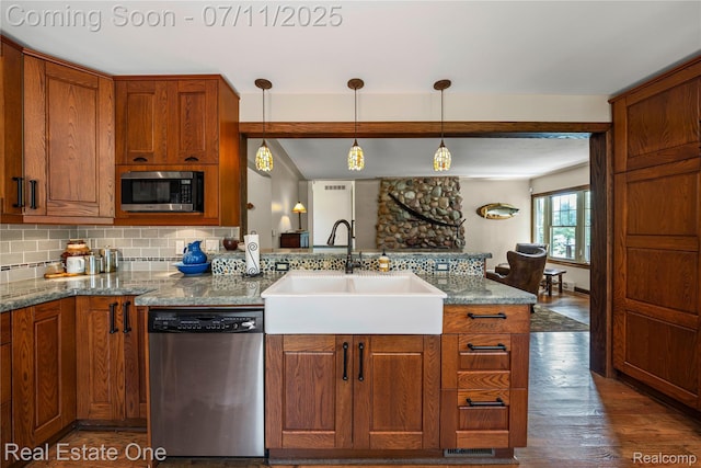 25740 Farmbrook Rd, Southfield, MI 48034 - kitchen featuring stainless steel appliances, backsplash, a peninsula, and brown cabinets