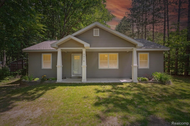 3416 Abbottsford Rd, Clyde, MI 48049 - bungalow with a front yard, a shingled roof, and a porch