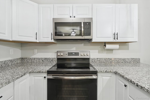 3416 Abbottsford Rd, Clyde, MI 48049 - kitchen featuring appliances with stainless steel finishes, white cabinetry, and light stone counters