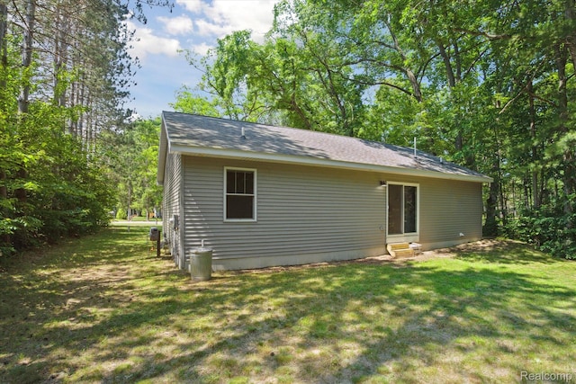 3416 Abbottsford Rd, Clyde, MI 48049 - rear view of house featuring a yard, roof with shingles, and entry steps