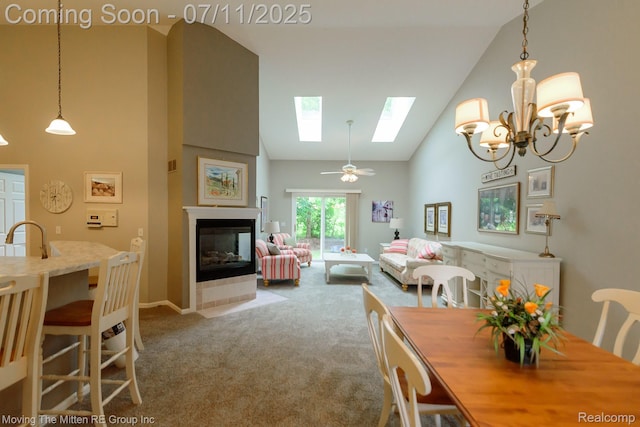 61001 Evergreen Ct, South Lyon, MI 48178 - dining space with high vaulted ceiling, a skylight, carpet flooring, a multi sided fireplace, and a chandelier