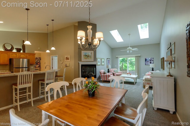 61001 Evergreen Ct, South Lyon, MI 48178 - dining area with high vaulted ceiling, light carpet, and a skylight