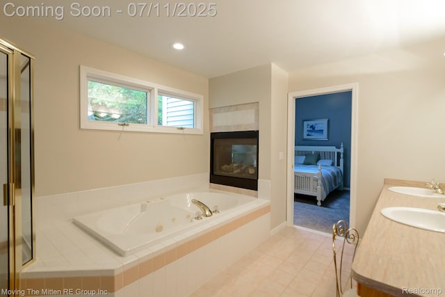 61001 Evergreen Ct, South Lyon, MI 48178 - bathroom with a tub with jets, tile patterned flooring, double vanity, a tiled fireplace, and ensuite bath