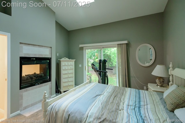 61001 Evergreen Ct, South Lyon, MI 48178 - bedroom with access to outside, a fireplace, lofted ceiling, and carpet flooring