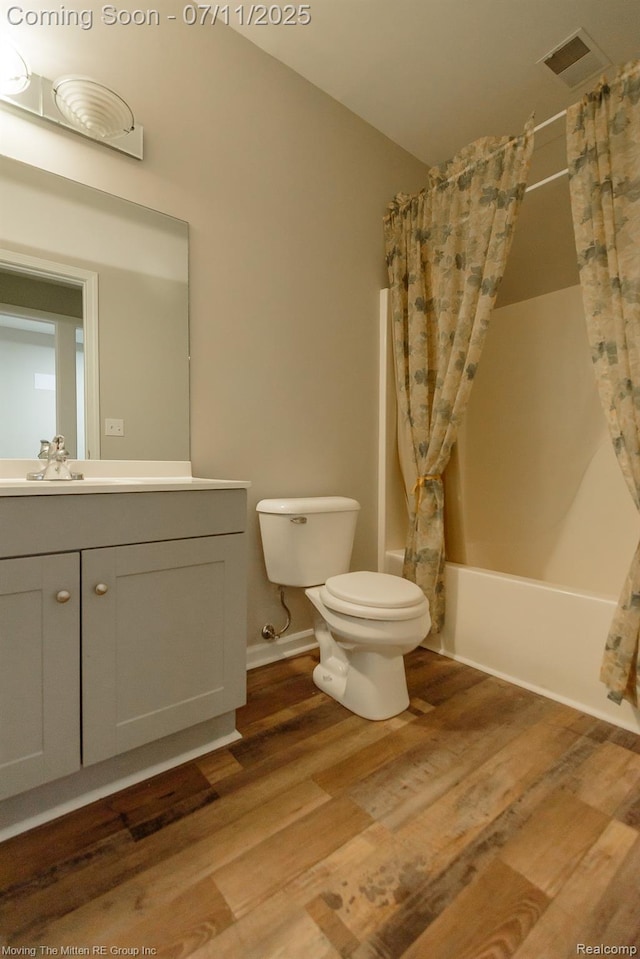 61001 Evergreen Ct, South Lyon, MI 48178 - full bath featuring shower / tub combo with curtain, wood finished floors, and vanity