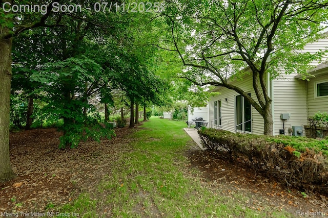 61001 Evergreen Ct, South Lyon, MI 48178 - view of green lawn featuring a patio area