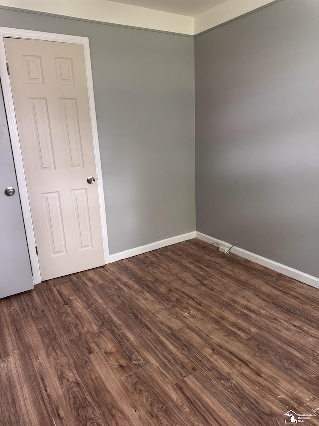 6114 Hazel St, Taylor, MI 48180 - spare room with dark wood-style flooring and baseboards