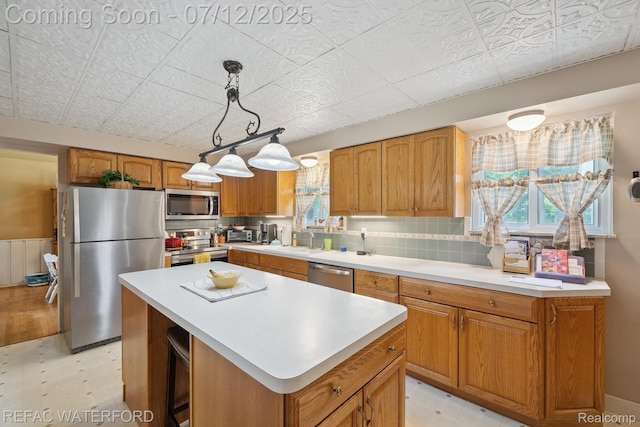 11857 Ely Rd, Davisburg, MI 48350 - kitchen with appliances with stainless steel finishes, plenty of natural light, a center island, and light countertops
