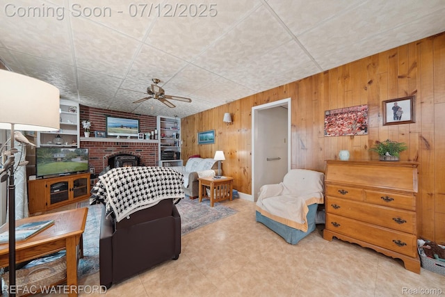 11857 Ely Rd, Davisburg, MI 48350 - living room with ceiling fan, wood walls, and a fireplace