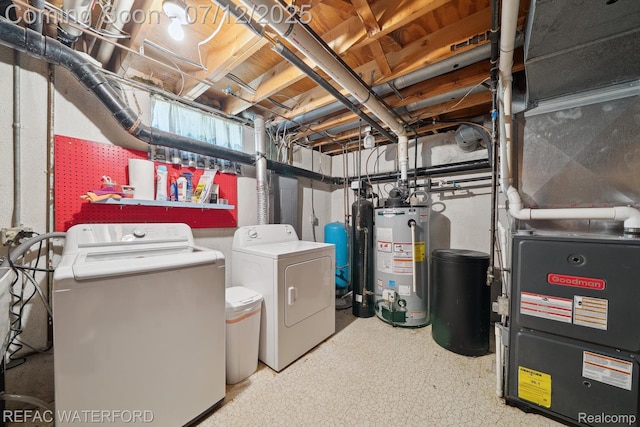 11857 Ely Rd, Davisburg, MI 48350 - unfinished below grade area featuring washer and clothes dryer, gas water heater, heating unit, and a water pressure tank