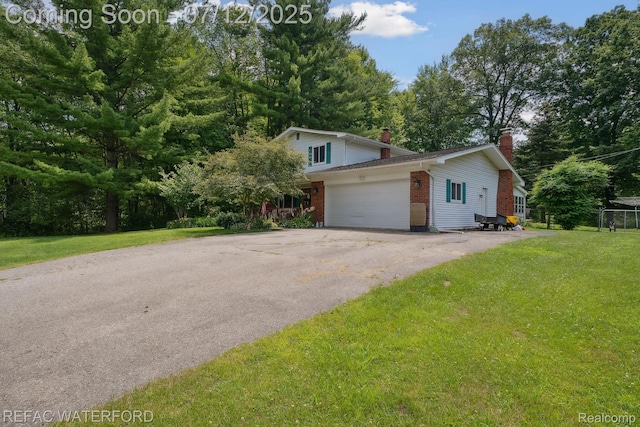 11857 Ely Rd, Davisburg, MI 48350 - view of front of property with brick siding, a chimney, an attached garage, a front lawn, and driveway