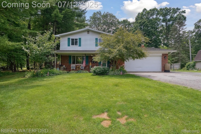 11857 Ely Rd, Davisburg, MI 48350 - view of front facade with asphalt driveway, brick siding, a porch, and a front lawn