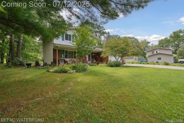 11857 Ely Rd, Davisburg, MI 48350 - view of front of home with a porch, a front yard, driveway, and brick siding