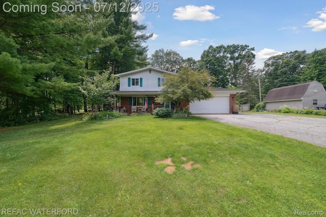 11857 Ely Rd, Davisburg, MI 48350 - view of front facade with covered porch, driveway, a front lawn, an attached garage, and brick siding