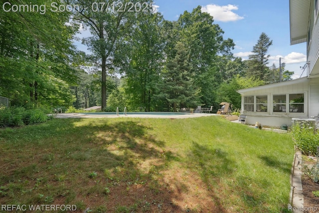 11857 Ely Rd, Davisburg, MI 48350 - view of green lawn with an outdoor pool