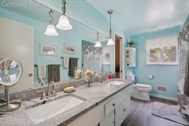 11857 Ely Rd, Davisburg, MI 48350 - full bath featuring double vanity, wood finished floors, and a shower with curtain