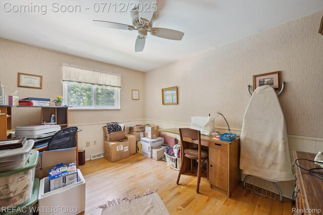 11857 Ely Rd, Davisburg, MI 48350 - home office featuring wood finished floors, a ceiling fan, and wainscoting