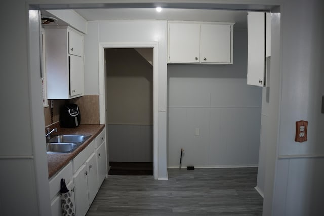 6422 Evergreen Rd, Detroit, MI 48228 - kitchen with wood finished floors, white cabinetry, a wainscoted wall, and dark countertops