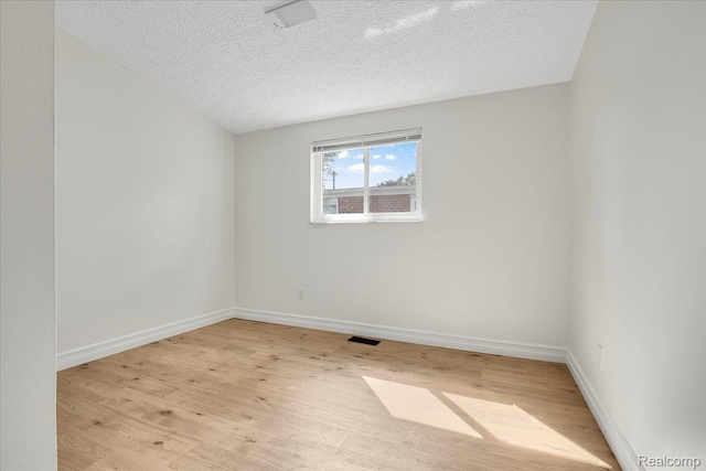 22809 Detour St, Macomb, MI 48082 - empty room featuring a textured ceiling and light wood finished floors