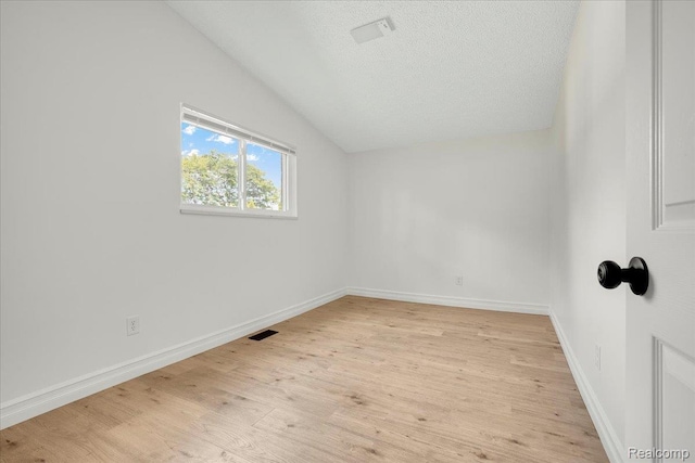 22809 Detour St, Macomb, MI 48082 - spare room with vaulted ceiling, light wood-type flooring, and a textured ceiling