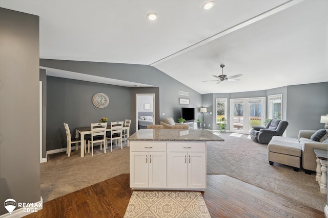 9164 Emily Dr, Davison, MI 48423 - kitchen with vaulted ceiling, white cabinetry, dark wood-style floors, dark colored carpet, and open floor plan