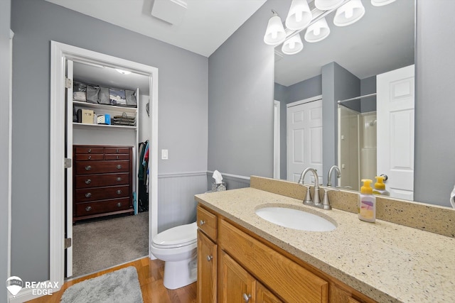 9164 Emily Dr, Davison, MI 48423 - full bath featuring vanity, wood finished floors, a shower, a spacious closet, and a wainscoted wall
