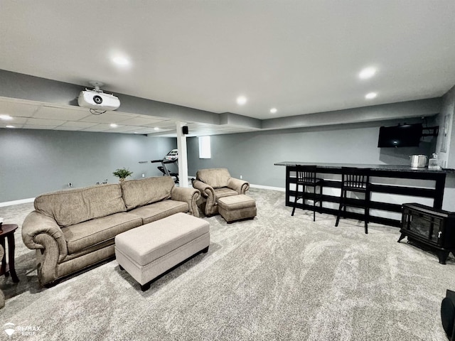 9164 Emily Dr, Davison, MI 48423 - living area featuring carpet flooring, recessed lighting, a wood stove, and bar area