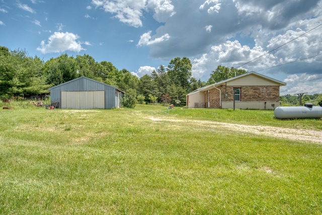 4180 15 Mile Rd, Barryton, MI 49305 - view of grassy yard with an outbuilding, a detached garage, and an outdoor structure
