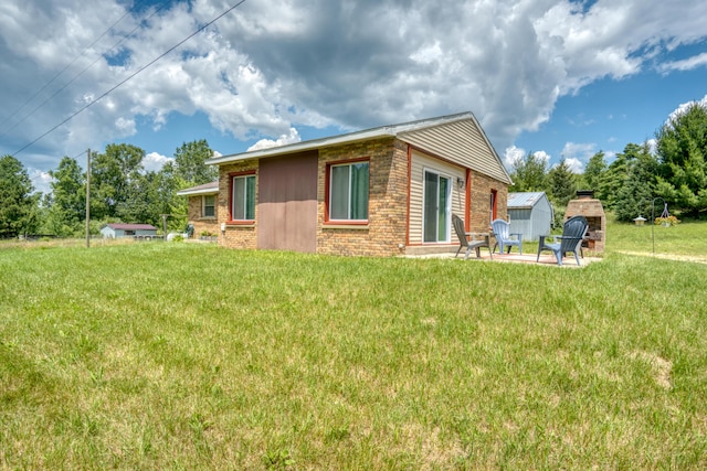 4180 15 Mile Rd, Barryton, MI 49305 - back of property with brick siding, a storage shed, and a yard