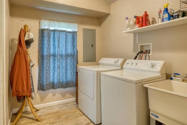 4180 15 Mile Rd, Barryton, MI 49305 - laundry area with electric panel, washing machine and dryer, and light wood-style flooring