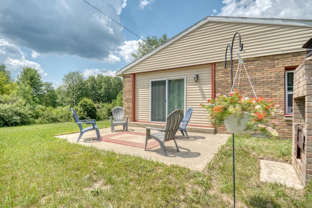 4180 15 Mile Rd, Barryton, MI 49305 - rear view of property with brick siding, a patio, and a yard