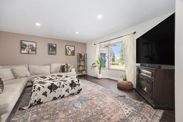 14555 Fruit Ridge Ave, Kent City, MI 49330 - living room with dark wood-style floors, recessed lighting, and a glass covered fireplace