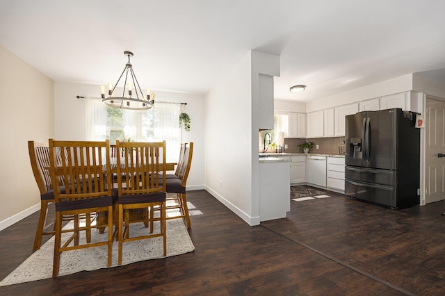 14555 Fruit Ridge Ave, Kent City, MI 49330 - dining space with a chandelier and dark wood-style flooring