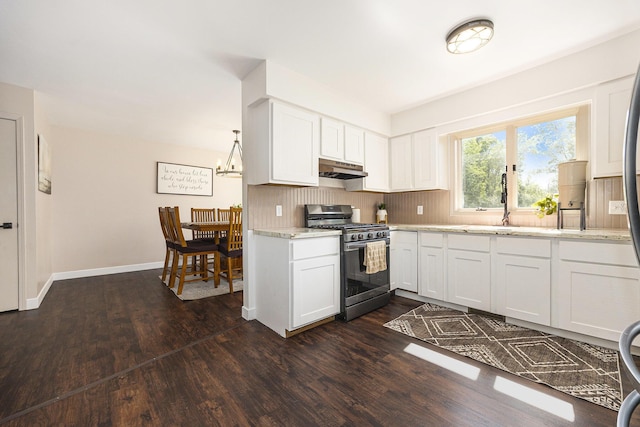 14555 Fruit Ridge Ave, Kent City, MI 49330 - kitchen with stainless steel gas range, under cabinet range hood, dark wood-style flooring, white cabinetry, and light stone countertops