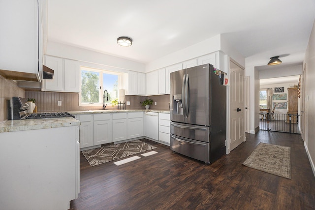 14555 Fruit Ridge Ave, Kent City, MI 49330 - kitchen with stainless steel fridge, white dishwasher, range, white cabinetry, and dark wood-type flooring