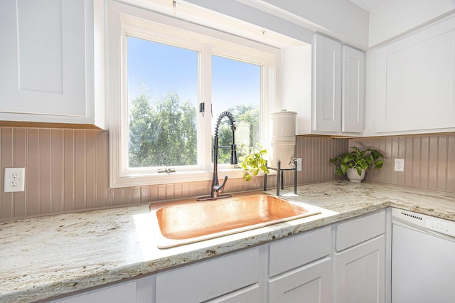14555 Fruit Ridge Ave, Kent City, MI 49330 - kitchen featuring dishwasher, white cabinets, wooden walls, and light stone counters