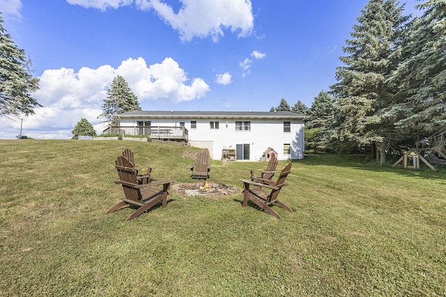 14555 Fruit Ridge Ave, Kent City, MI 49330 - back of property featuring a deck, a yard, and an outdoor fire pit